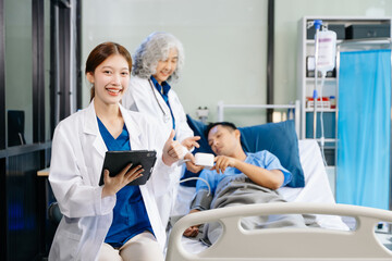 Fototapeta premium Hospital Ward Male and Male Professional Asian Doctors Talk with a Patient, Give Health Care Advice,