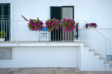 White and flowery facade of a house in Monopoli, Italy