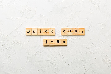 quick cash loan word written on wood block. quick cash loan text on table, concept