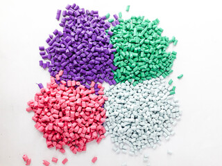 Various colors of masterbatch granules isolated on white background, polymer carriers of color...