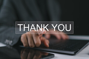 Businesswoman using a laptop and touching the message thank you on a display screen. Concept of thank you business, congratulations, and appreciation gratitude. Presentation from technology digital.