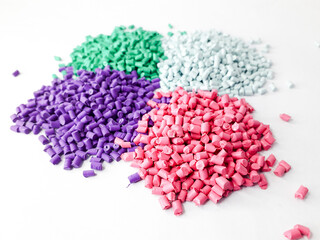 Various colors of masterbatch granules isolated on white background, polymer carriers of color pigments in the plastics industry