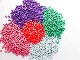 Various colors of masterbatch granules isolated on white background, polymer carriers of color...