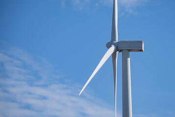 Wind turbines against blue sky, Wind energy. Wind power. Sustainable, renewable energy. Wind turbine generate electricity. Sustainable resources. Green technology for energy sustainability.
