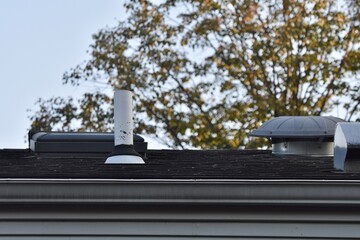 exhaust vents and vent stack on house roof