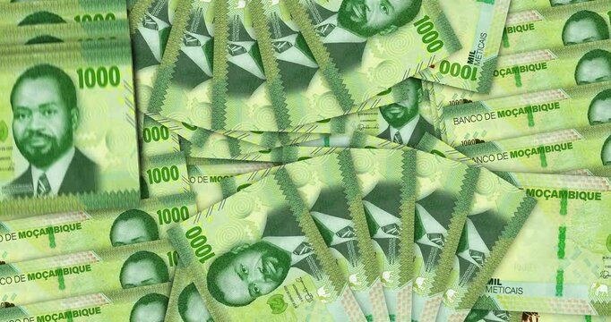 Mozambique money Mozambican Metical banknotes in a cash fan mosaic pattern loop. 1000 MZN notes. Abstract concept of bank, finance, economy seamless and looped design background.