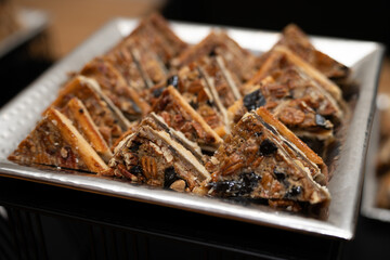 Dessert bars at an event in a plate, close up image of tasty treat at the coffee bar