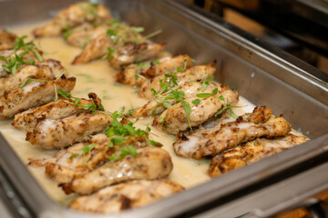 Coconut cream chicken, baked and served at an event in catering buffet dish
