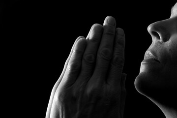 praying with hand on bible learning christianity and the faith of God with people stock image stock photo	
