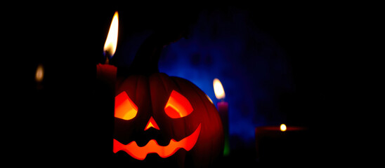 Fototapeta premium glowing jack-o-lantern with candles