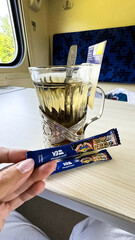 Packages of sugar against the background of a glass of tea. Ukraine, Ukrzaliznytsia, 2024 year