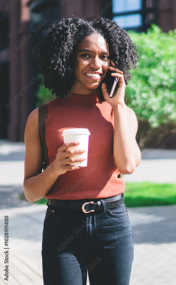 Poster half length portrait of cheerful female student with takeaway cup in hand smiling at camera while ma