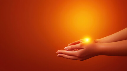 Hands holding light, orange background, symbolizing warmth and positivity.