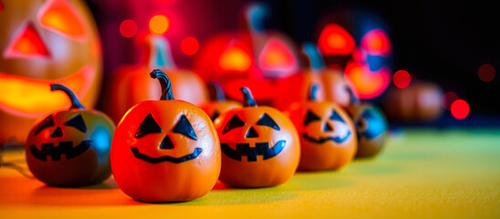 smiling carved pumpkins on a yellow surface