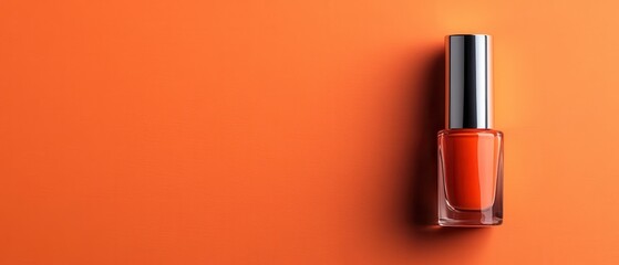 Obraz premium Vibrant orange backdrop showcases a single bottle of nail polish