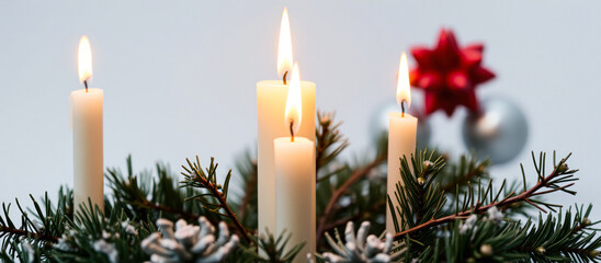 lit evergreen wreath with five burning candles