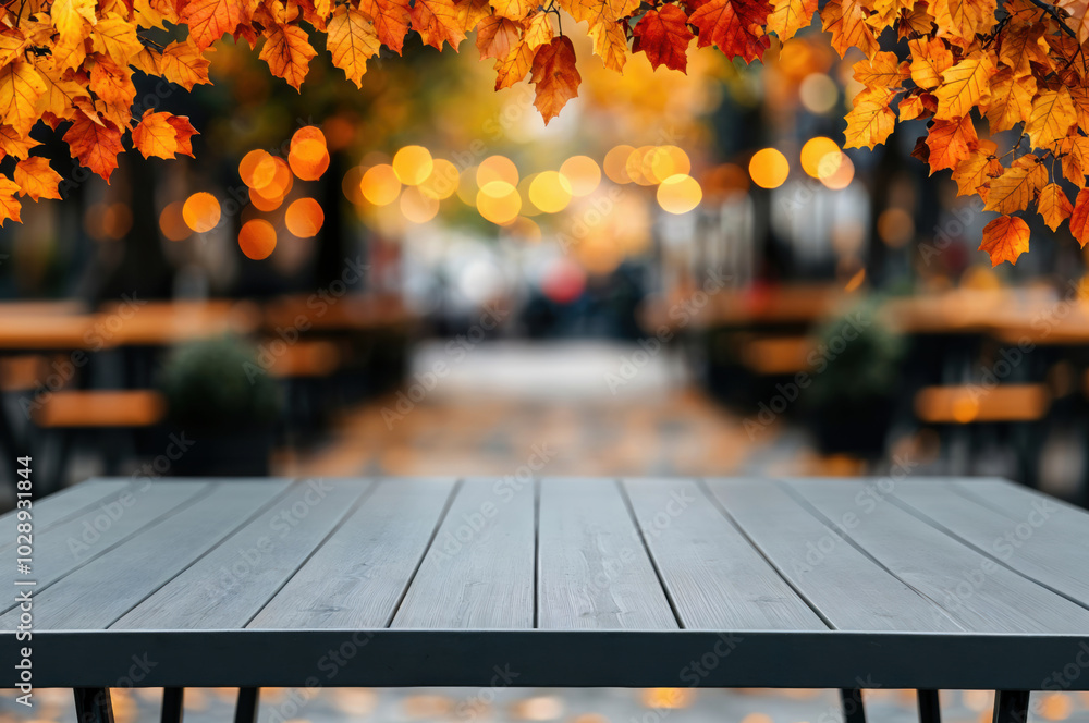 Poster Empty wooden table showing autumn background with falling leaves for a seasonal display