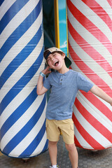 boy leaving a fun house in a carnival 