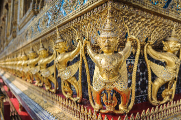 Fototapeta premium Golden sculptures of garuda and naga, wat phra kaew (temple of the emerald buddha), bangkok, thailand, southeast asia.