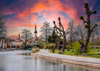 View of the town of Luebbenau in the Spreewald with church and sunset