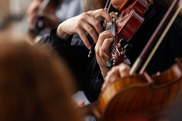 Close-up of violinist's hands in orchestra