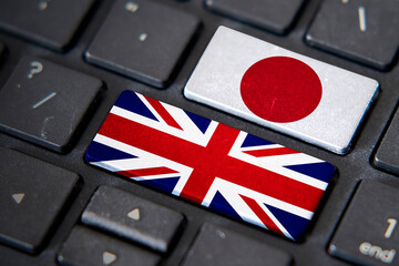 UK and Japan flags on computer keyboard