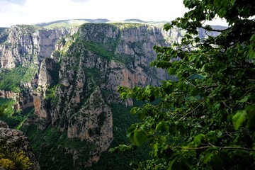 
Panoramic view over the steep and green cliffs of the Vikos Gorge in Epirus, Greece on a summer's day. The gorge in the Pindus Mountains is one of the deepest gorges in the world. Hiking in Greece