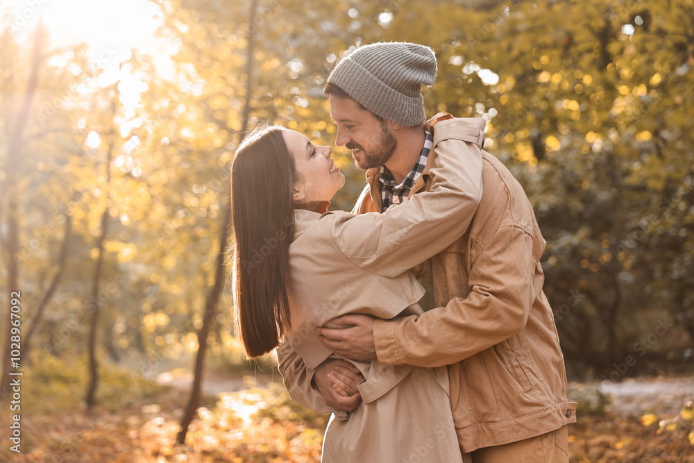 Poster Beautiful couple spending time in park on autumn day