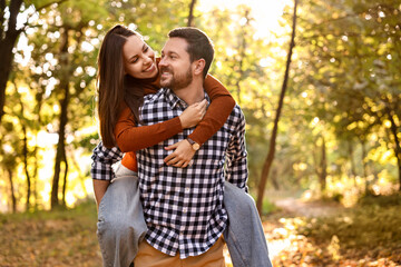 Fototapeta premium Beautiful couple having fun together in park on autumn day