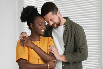 International relationships. Portrait of lovely couple at home