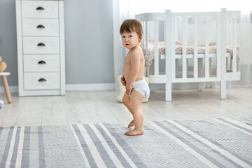 Fototapeta premium Cute little child in diaper at home