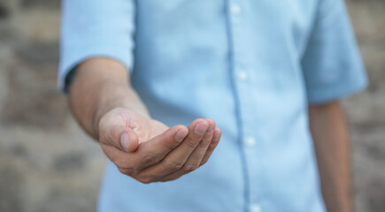 Young caucasian man showing empty hand.