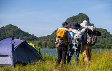 Family appears to be preparing for a hiking or camping expedition, as they are all equipped with...