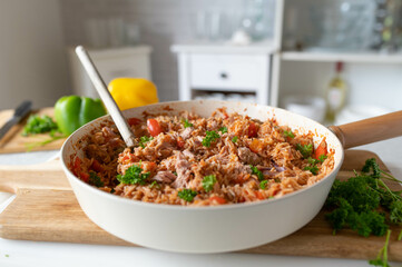 Healthy homemade food with a  tuna rice vegetable skillet on kitchen counter