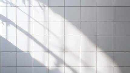 Obraz premium Sunlight shining through a window onto a white tiled wall.