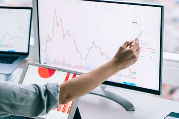 Professional woman working with graphs on computer