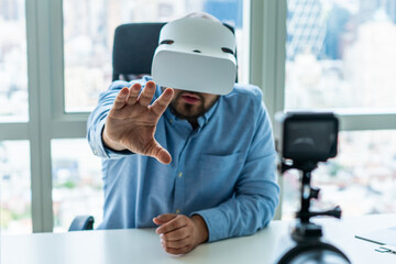 Man gesturing at camera using VR goggles