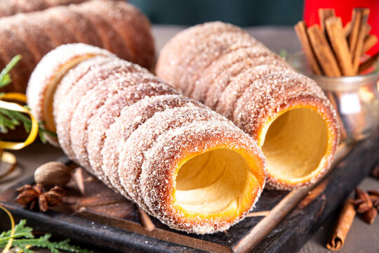Traditional East Europe Christmas sugar glazed dessert chimney cake, trdlo or trdelnik, sweet aromatic winter seasonal street food with cinnamon and spices