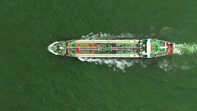 4k Aerial top view over international containers cargo ship at industrial import-export port prepare to load containers with big container loader ship vessel. 