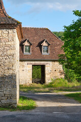 Empty natural stone farm house and barn in the last sunlight of the day in Cornac Lot Occitanie in Southern France	