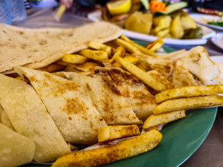 Delicious Middle Eastern Shawarma with Crispy Fries on Plate