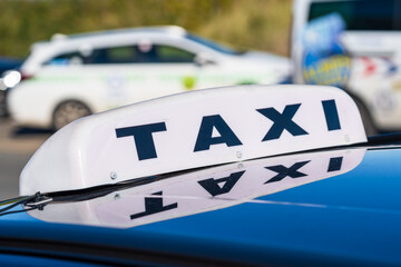 Taxi sign on top of a taxi cab or a private hire car