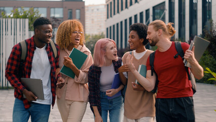 University friendship funny speaking emotional joyful diverse people teens high school pupils happy multiracial friends classmates multiethnic students smiling talking laughing walking city outdoors
