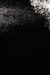 Abstract black and white background of pouring flour, space for text