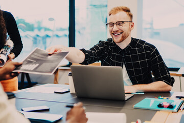Laughing people coworking at desk in office