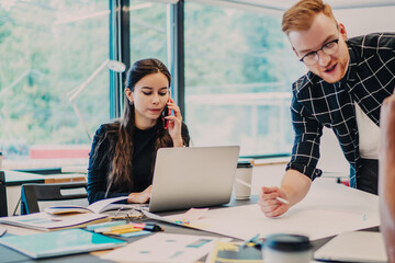 Office colleagues at desk with papers