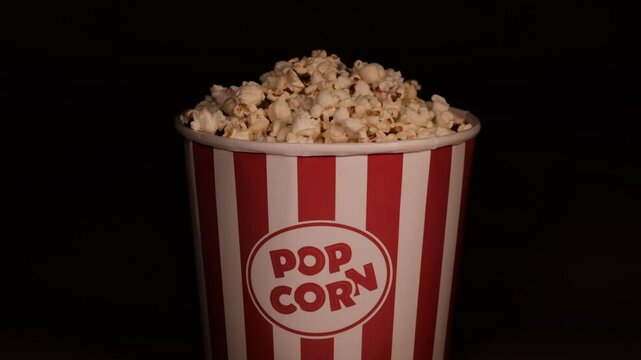 A large glass of delicious popcorn stands on the table.