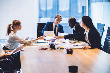 Coworking diverse colleagues in conference room