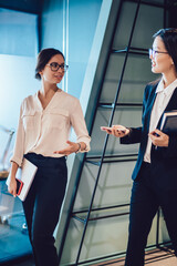 Stylish female colleagues in office