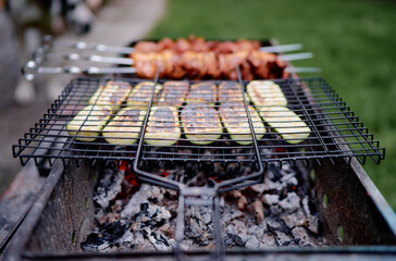 Barbecue chiken and zucchini. Cooking outdoor